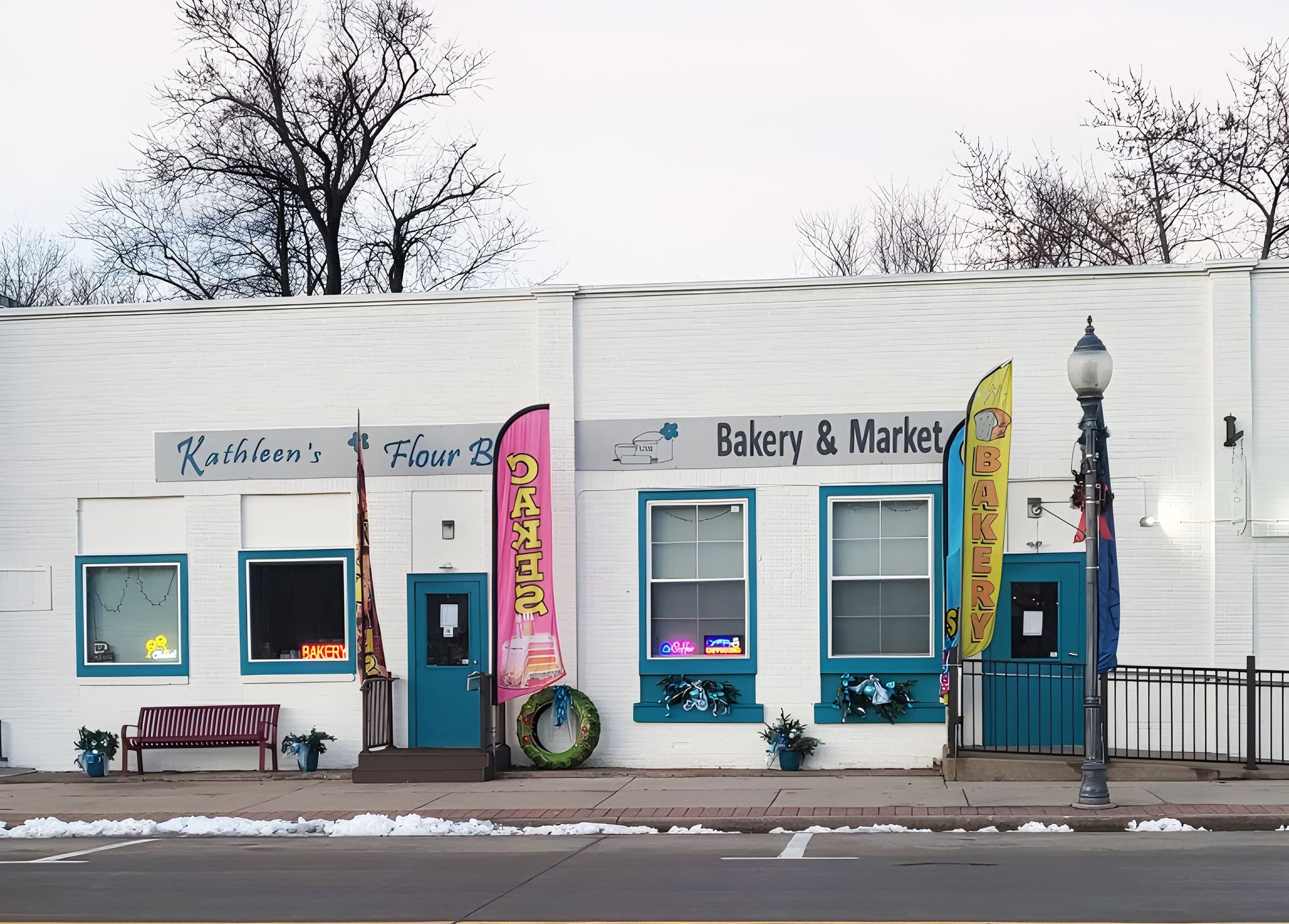 A white building with a bakery and market written on it