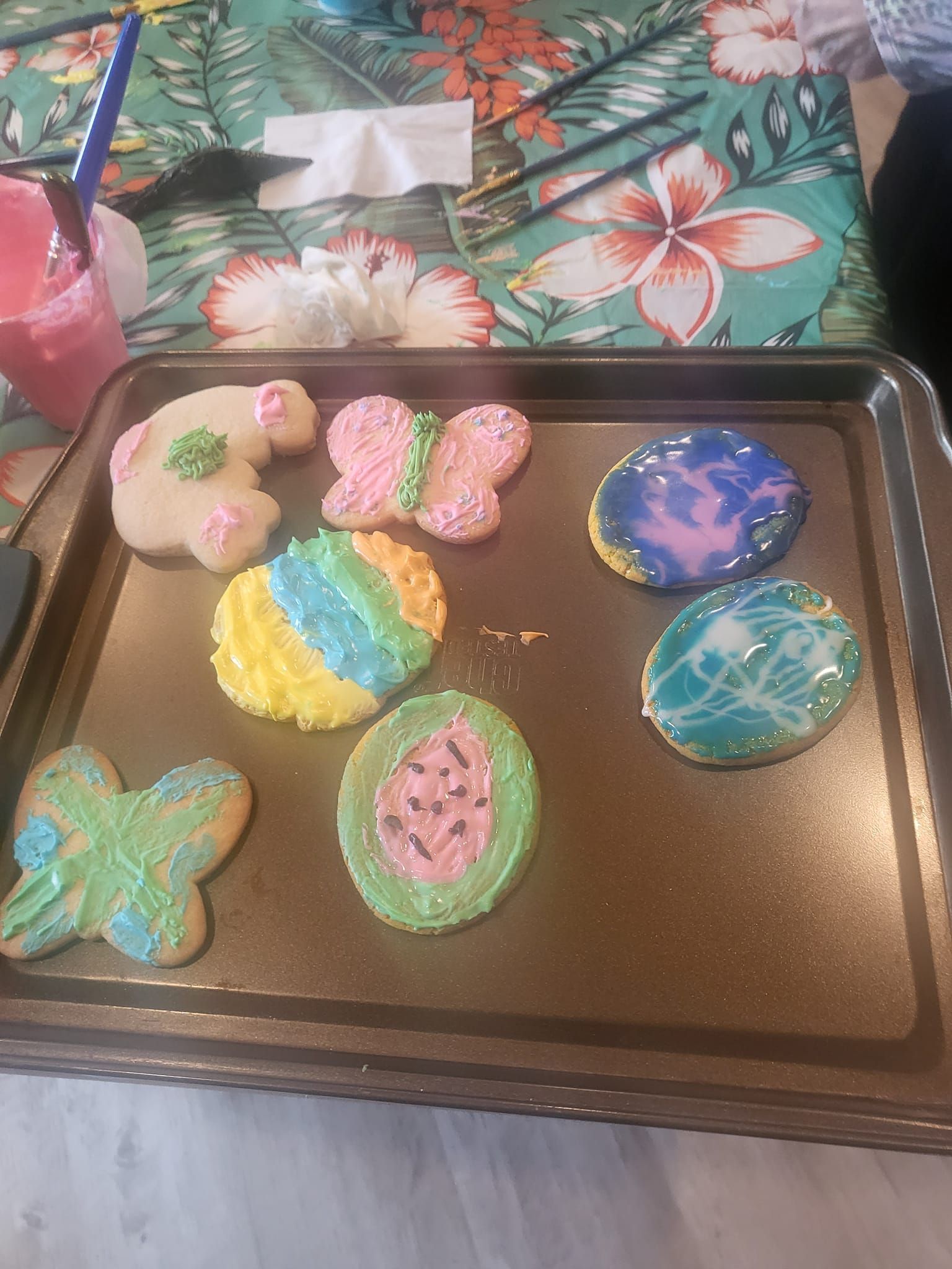 A tray of decorated cookies is sitting on a table.
