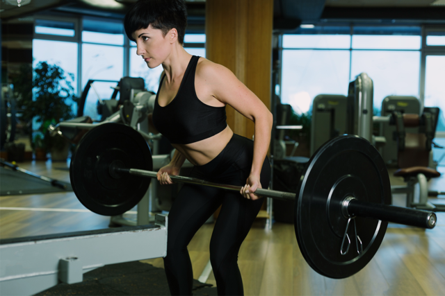 woman lifting weights at a gym