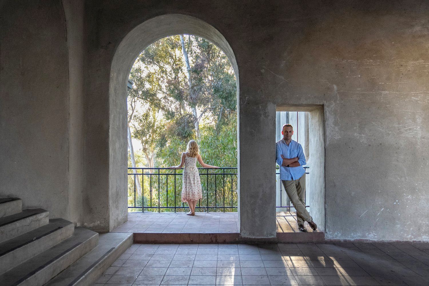 A man and a woman are standing next to each other in an archway.