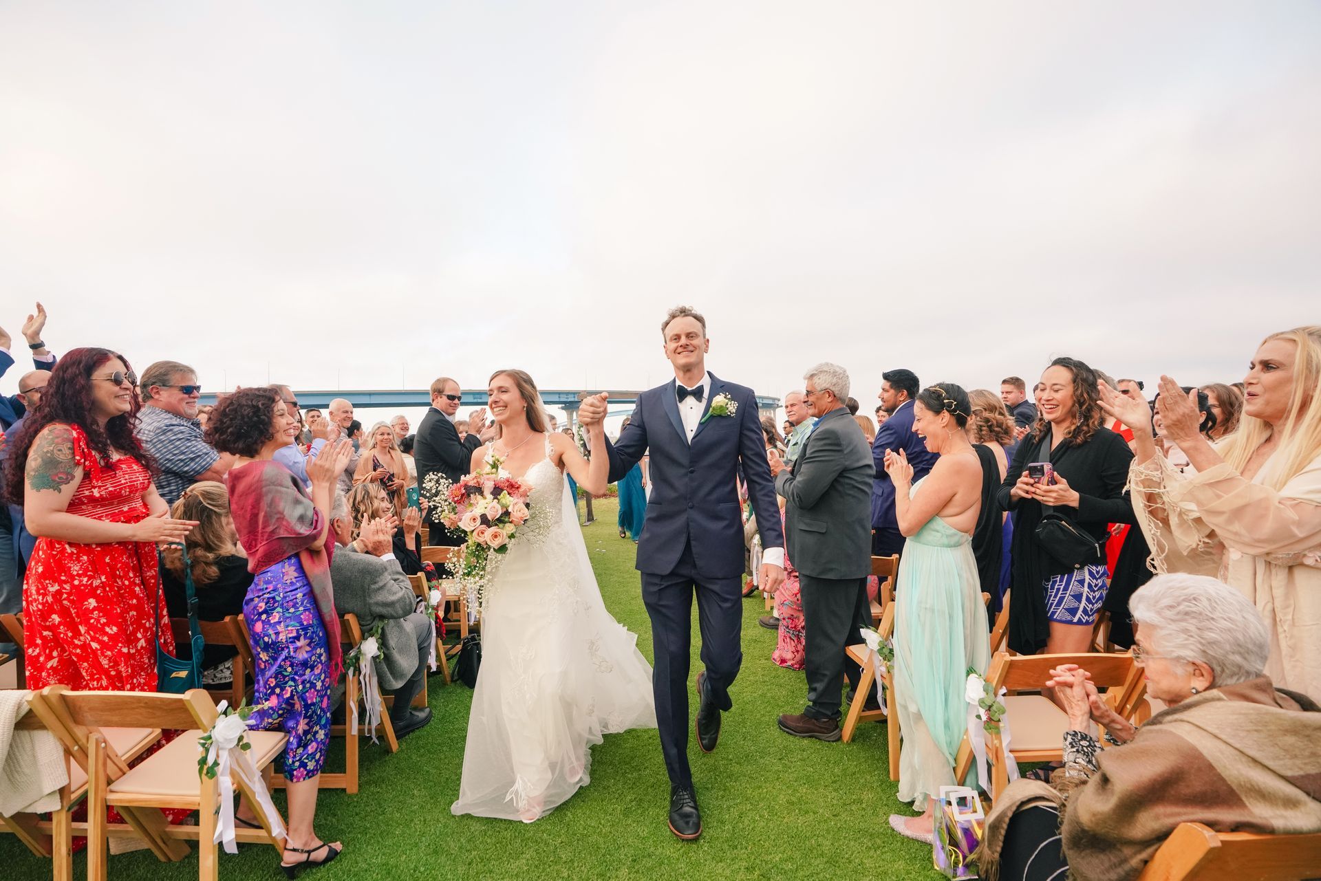A bride and groom are walking down the aisle at their wedding.