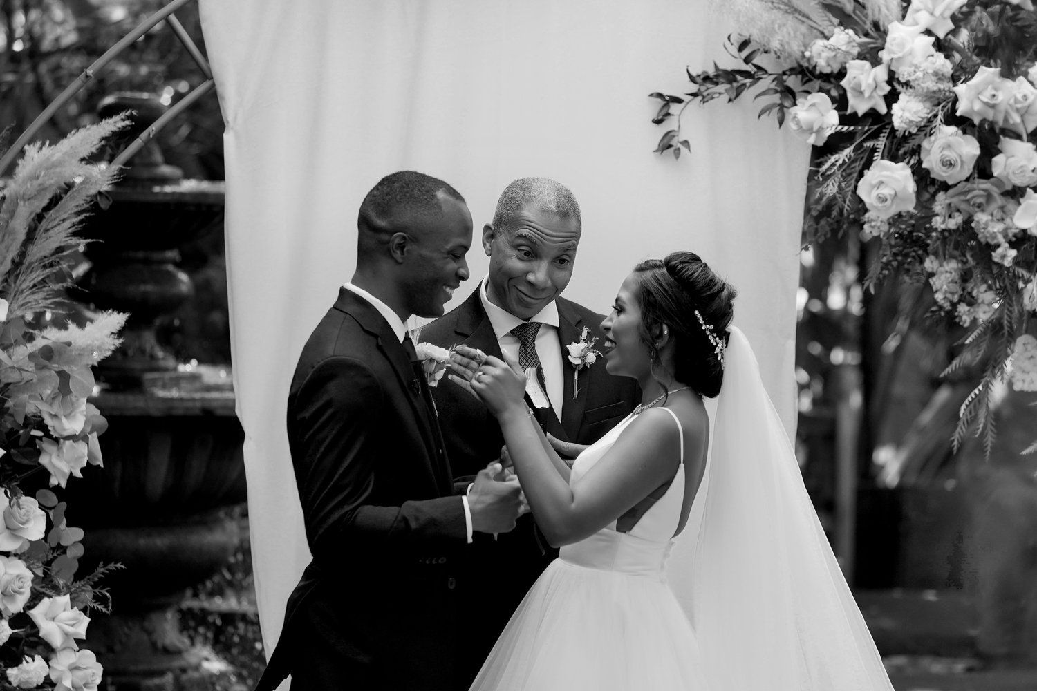 A black and white photo of a bride and groom at their wedding ceremony.