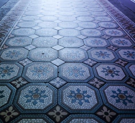 A blue and white tile floor with a floral pattern