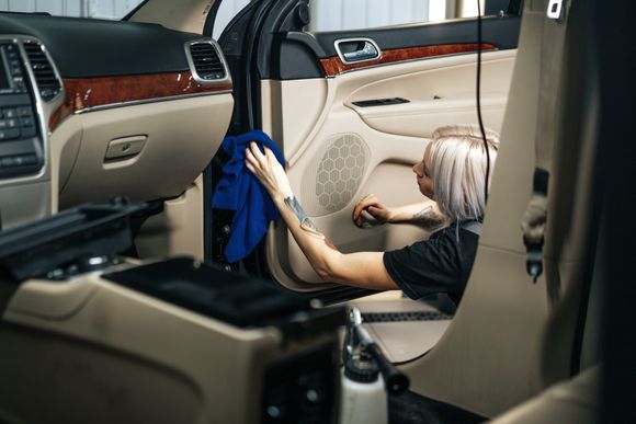 woman wiping the car interior