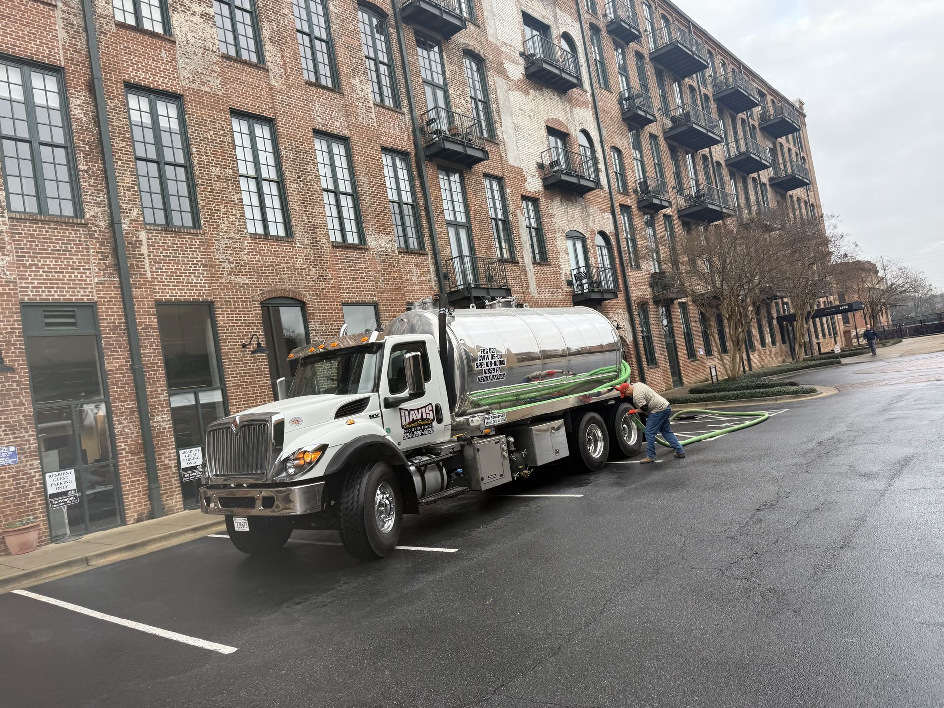 Lifting the cover off a septic tank in Phenix City, Al