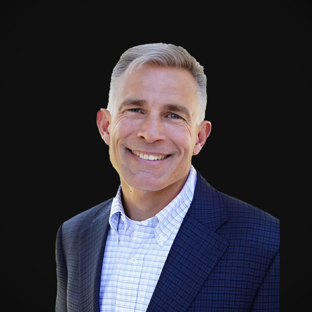 Michael Collins, Founder of Wazee Street Capital Management, smiling against a black background.