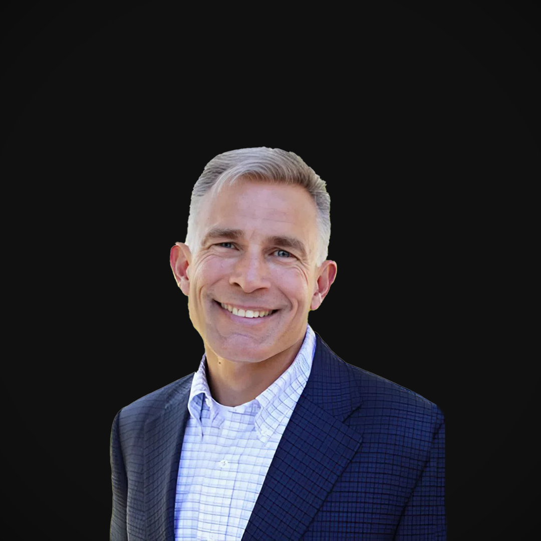 Michael Collins, Founder of Wazee Street Capital Management, smiling against a black background.