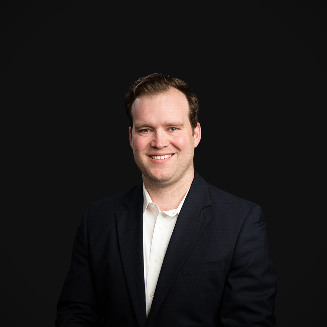 Jake Sundling from Wazee Street Capital Management smiling in front of a black backdrop.