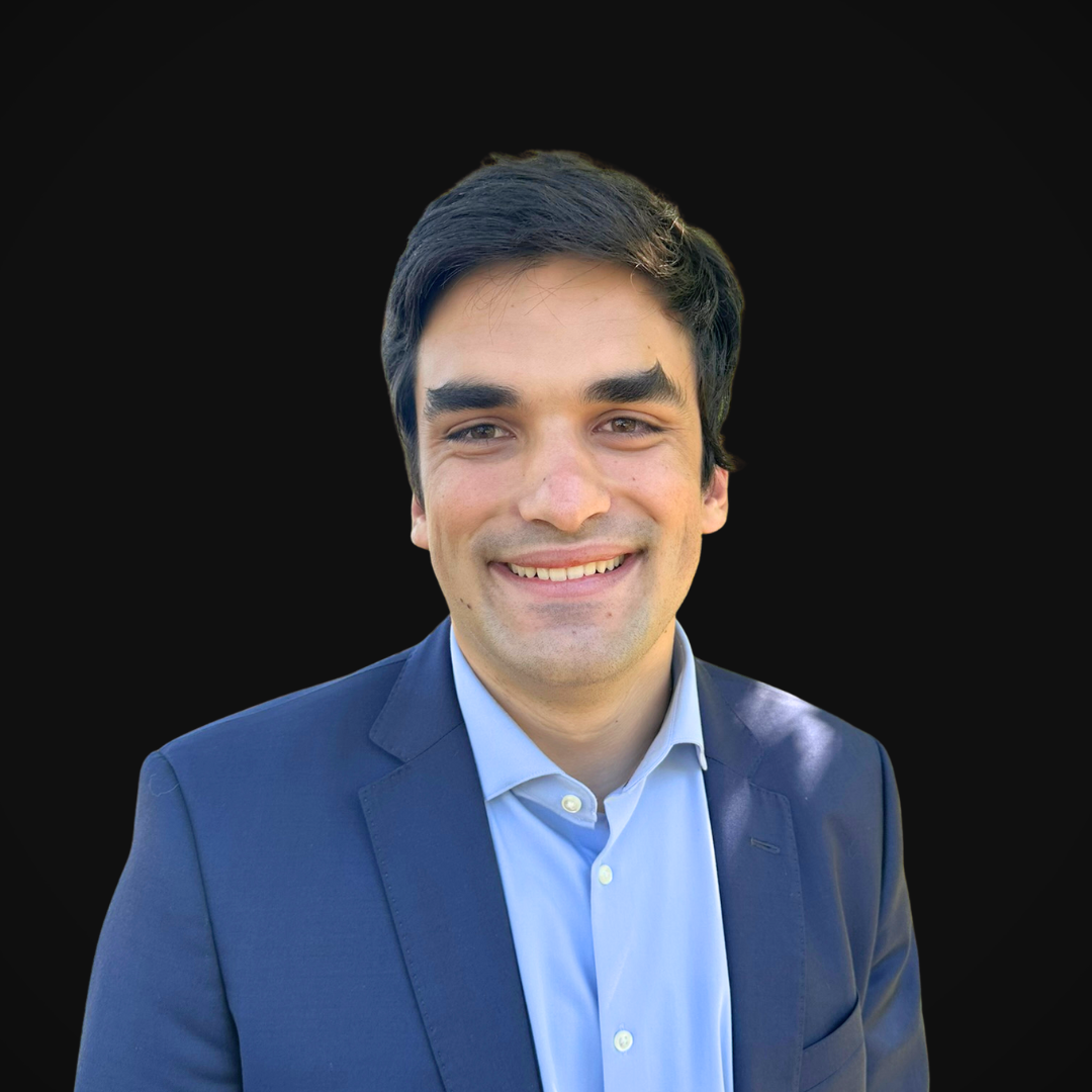 Matthew Collins from Wazee Street Capital Management smiling in front of a black backdrop.