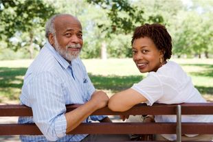 Man And A Woman Are Sitting On A Park Bench — Upland, CA — Embrace Health Insurance Agency