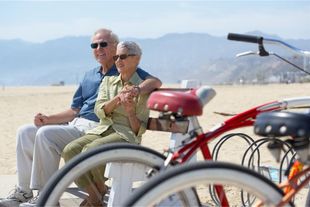 Man And Woman Are Sitting On A Bench — Upland, CA — Embrace Health Insurance Agency