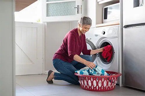 Woman Using Washing Machine — San Antonio, TX — Jesse & Sons Appliance Repair Solutions