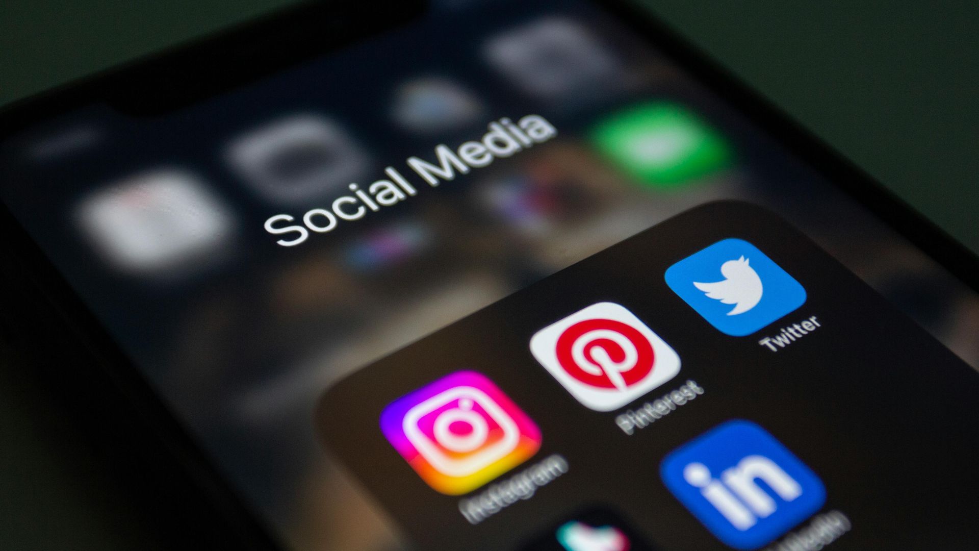 Smartphone displaying social media marketing apps used for digital advertising and business growth.