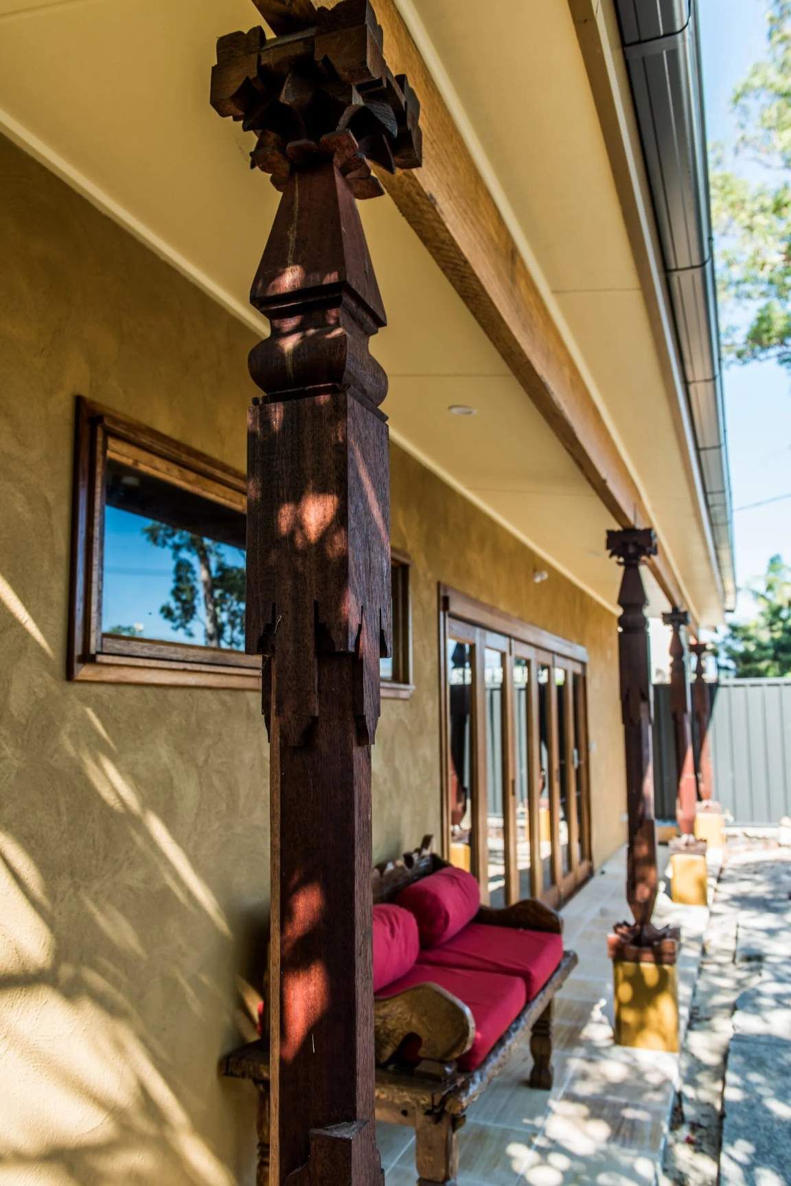 A Red Couch in Front of a House — Bali at the Bay in Nelson Bay, NSW