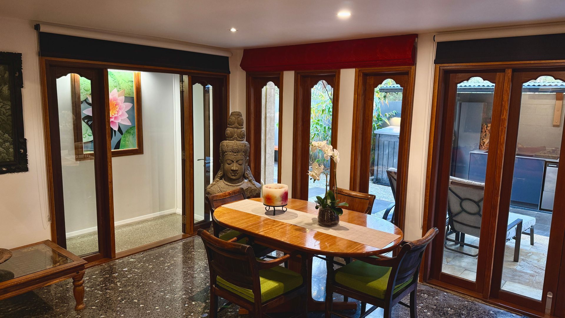 Dining room with a table and Buddha statue — Bali at the Bay in Nelson Bay, NSW