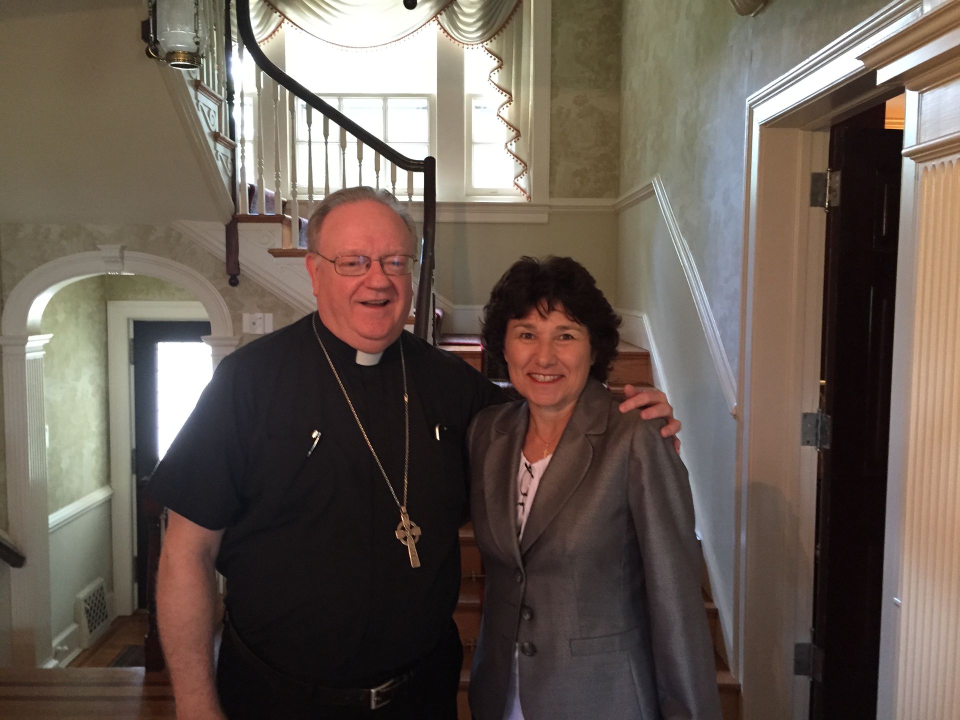 Rose standing with priest