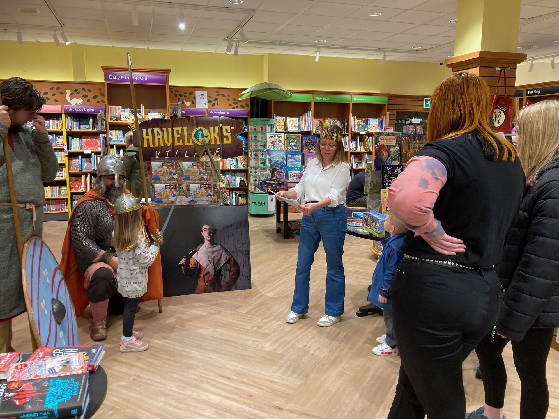 A group of people are standing in a bookstore.