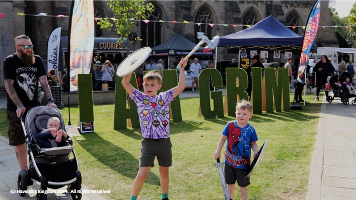 A group of children are standing in front of a sign that says grim.