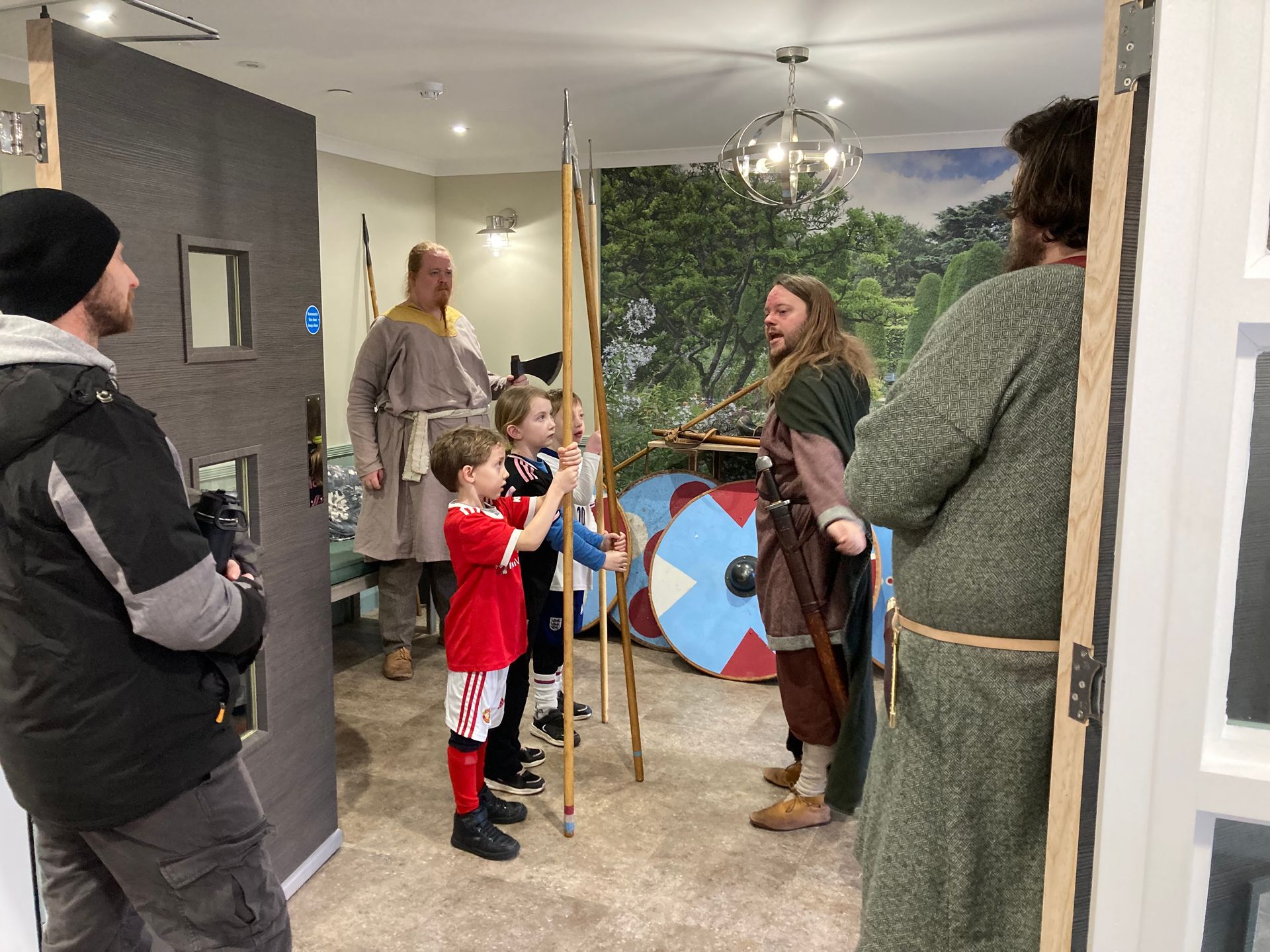 A group of people dressed in medieval costumes are standing in a room.