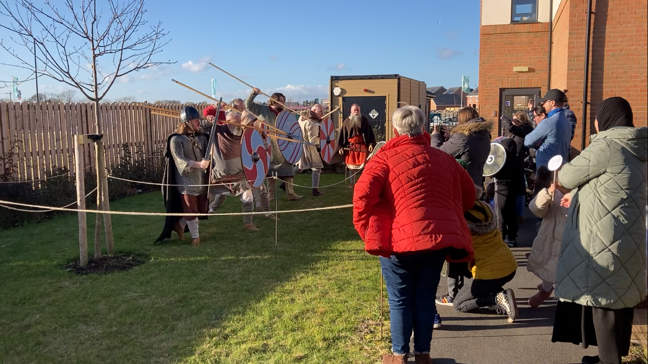 A group of people are standing outside of a building.