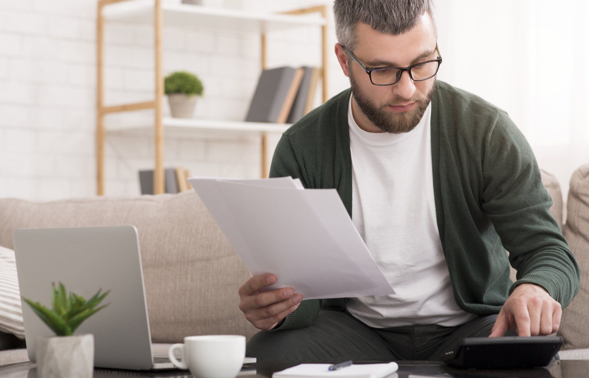 Auditing Services — Man Checking Bills at Home in Latham, NY