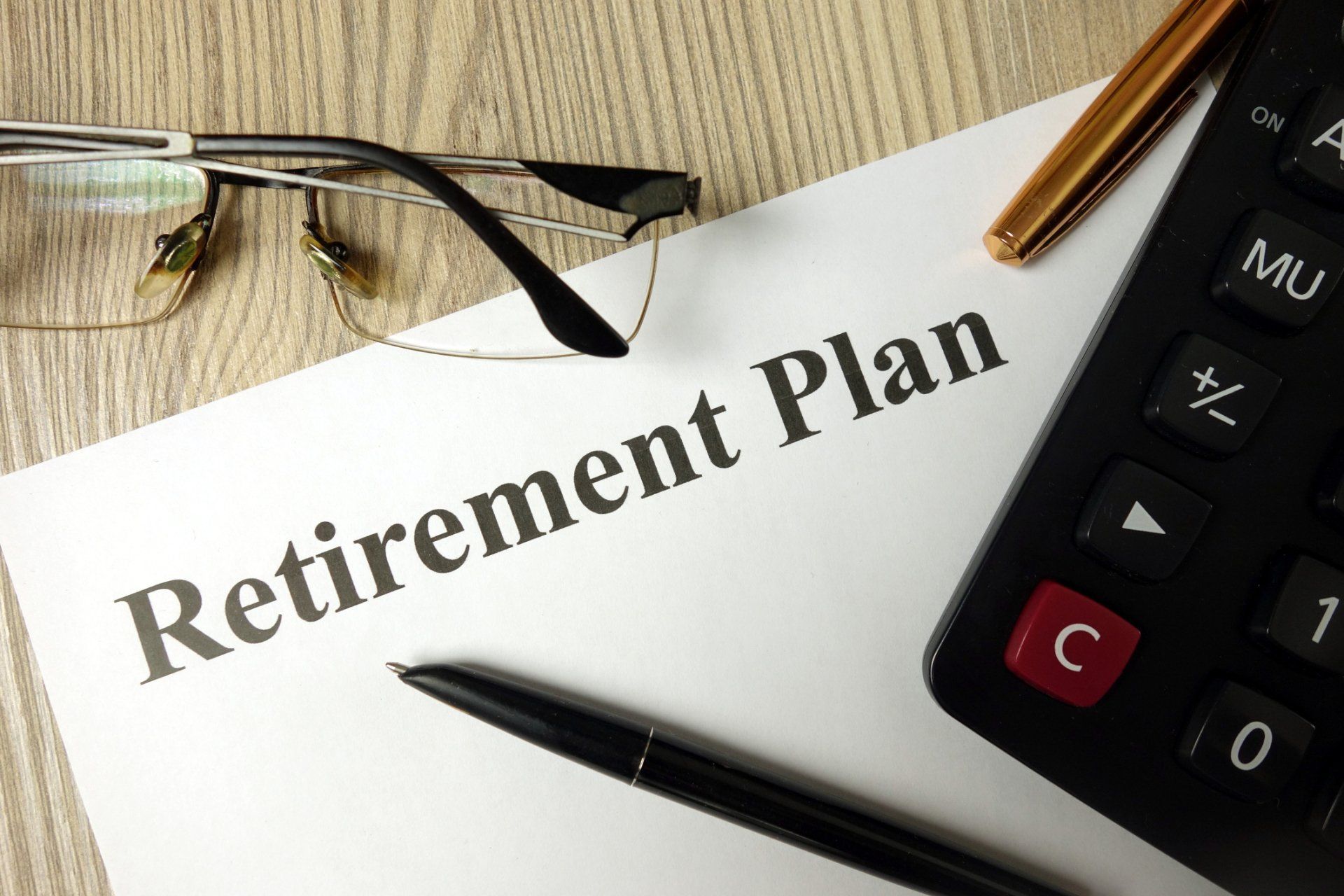 Tax Services — Retirement Plan With Calculator, Pen and Glasses in Latham, NY