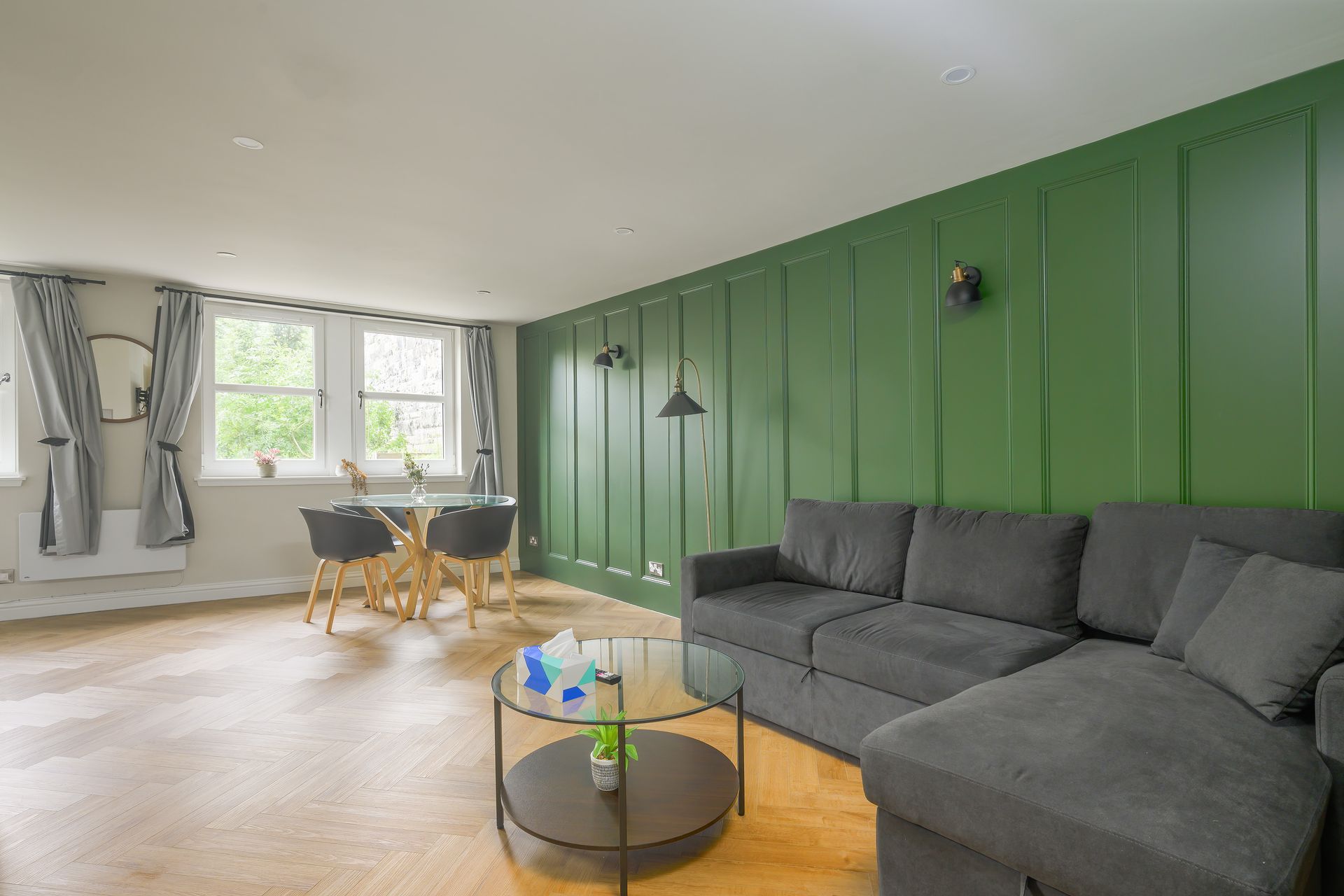 A bedroom with a bed , chair , desk and television.