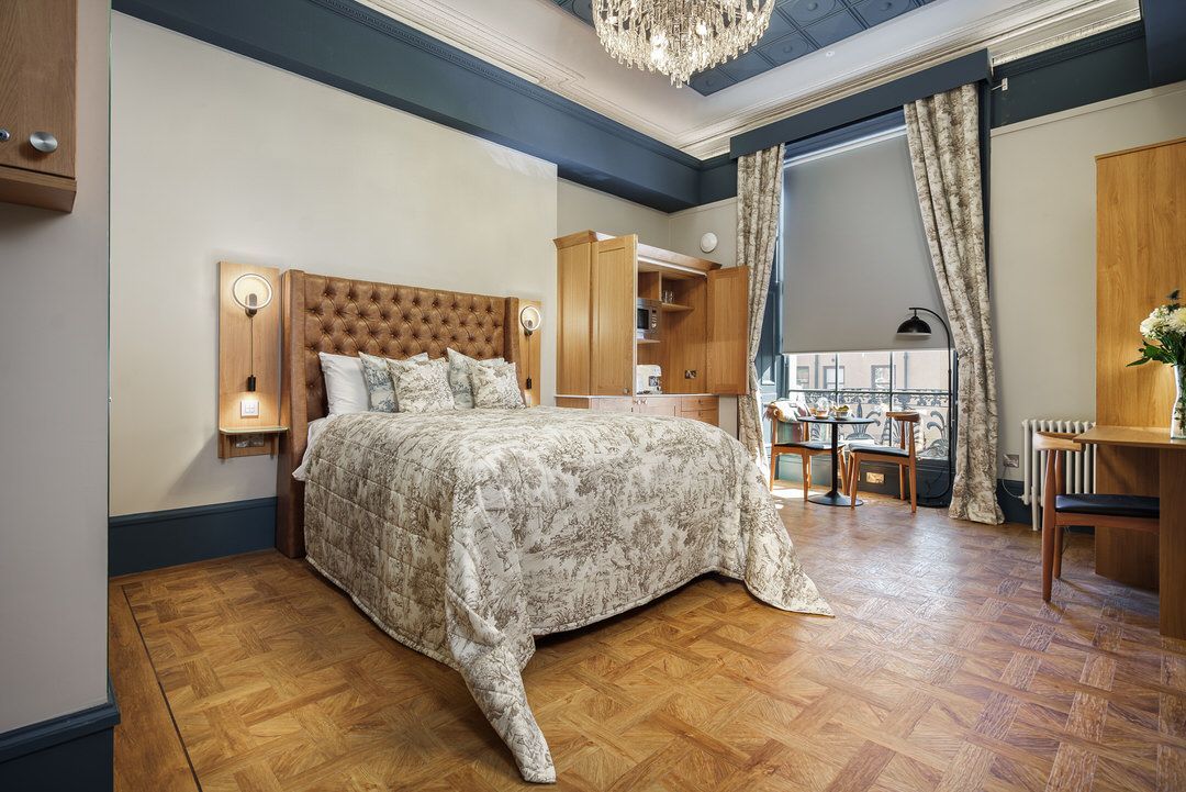 A bedroom with a bed , desk , chair and television.