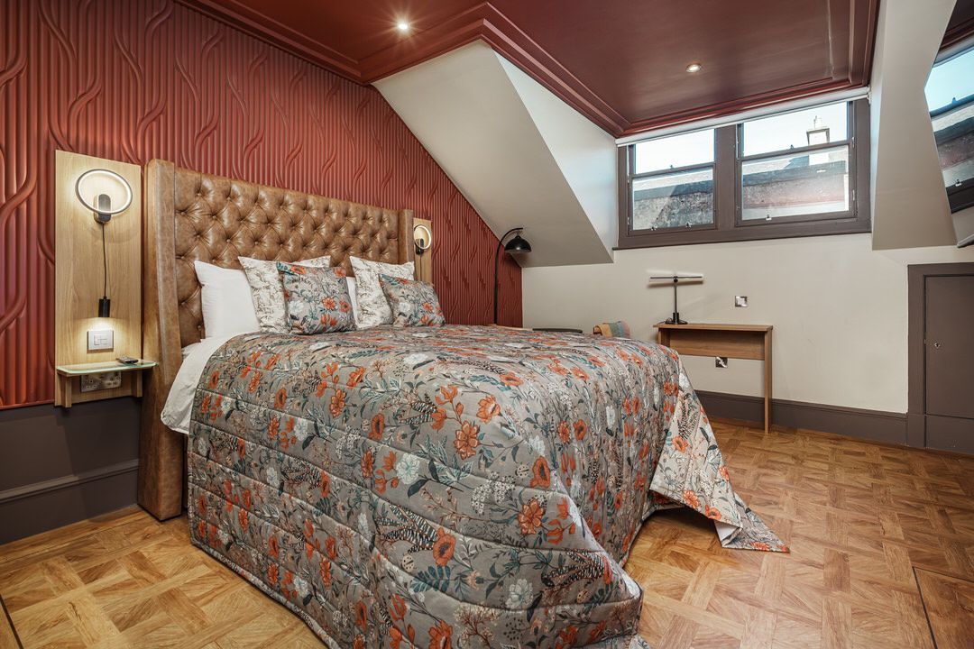 A bedroom with a large bed and a stove in it.