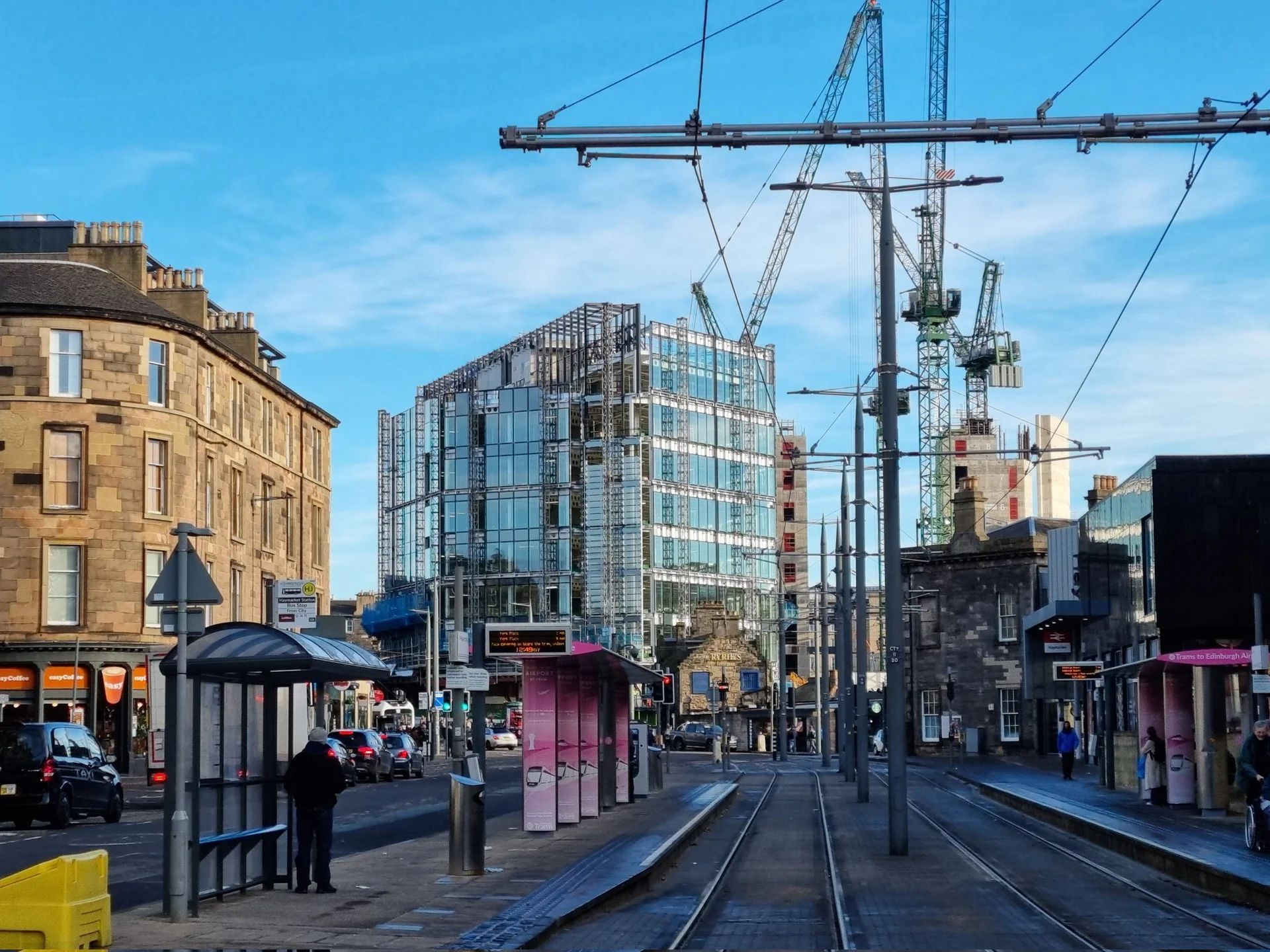 Edinburgh skyline with Gothic cathedral, tall spire, and historic buildings.