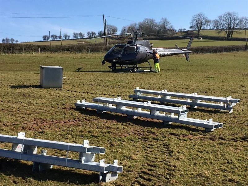Steel frames in field with helicopter