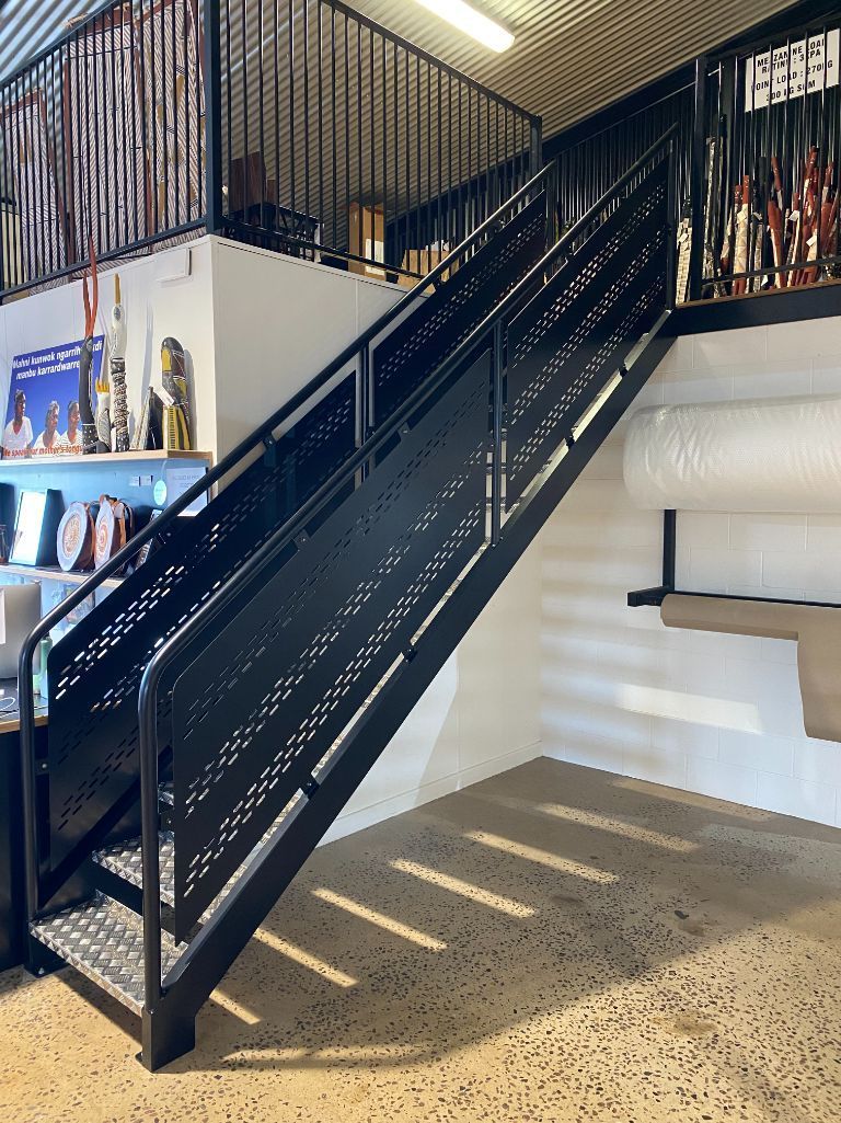 A black metal staircase leading up to a second floor — Local Builders in Yarrawonga, NT