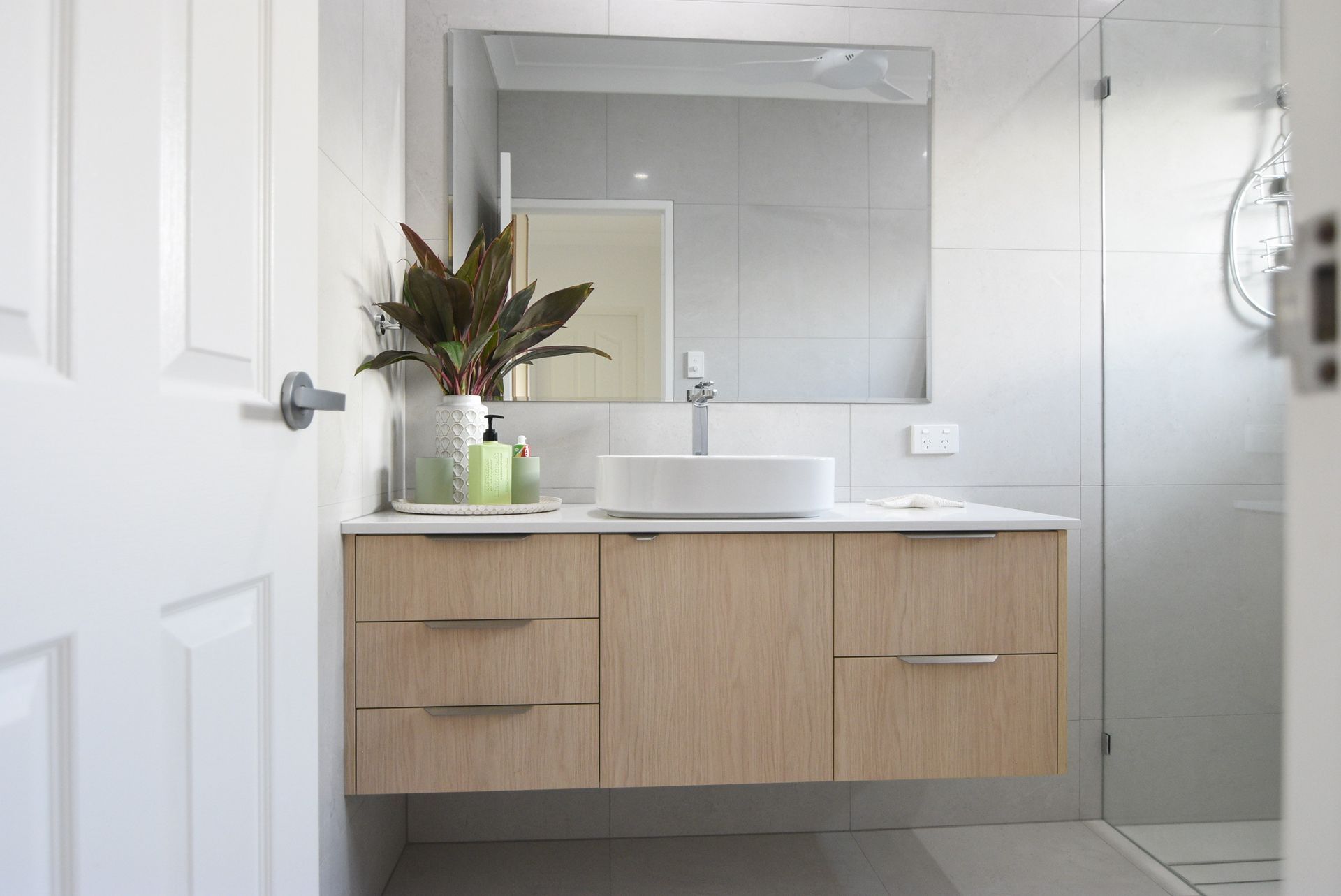 A Bathroom With a Wooden Vanity and a Walk in Shower — Custom Bathroom Renovations in Yarrawonga, NT