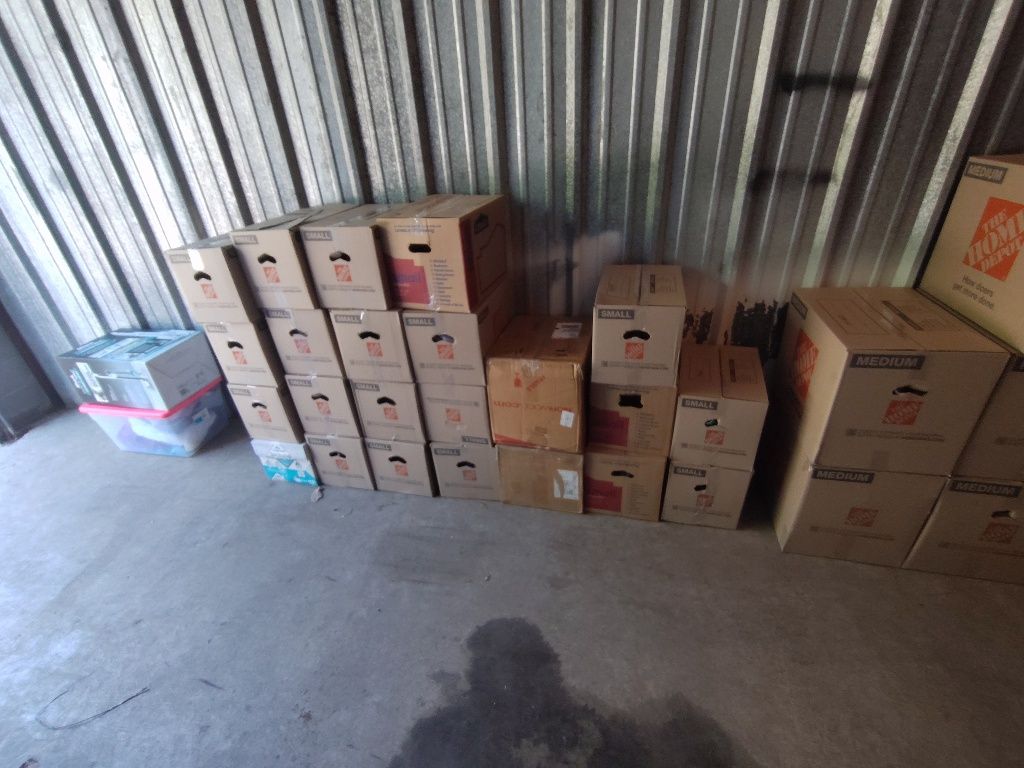 A bunch of cardboard boxes are stacked on top of each other in a room.