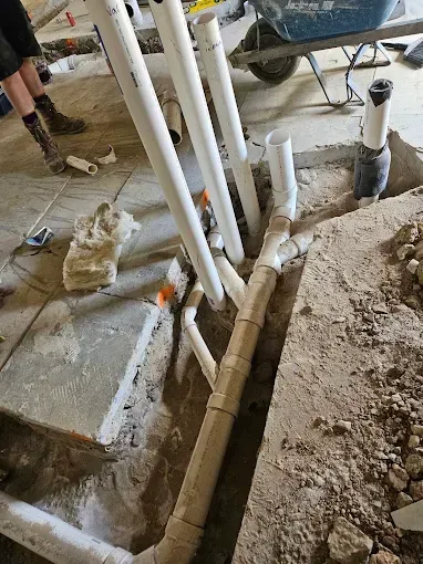 A bunch of pipes are being installed in a hole in the ground.