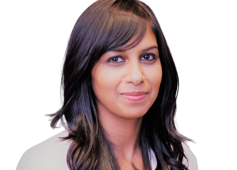 Headshot of a smiling woman with long dark hair on a white background