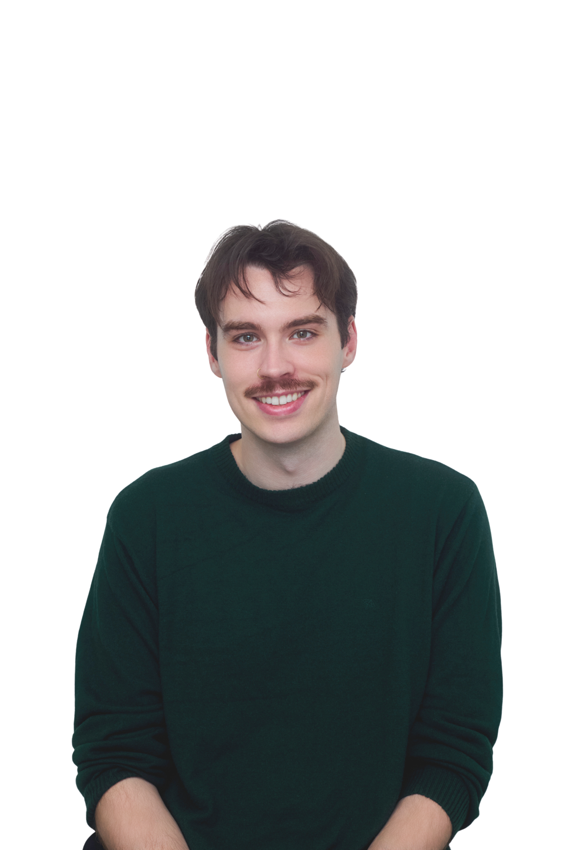 Man with dark hair and a mustache smiles, wearing a black sweater against a white background.