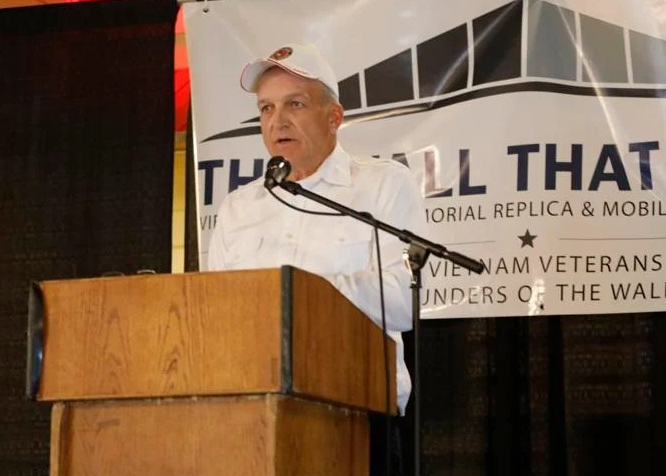 Michael Taapken speaking at a podium