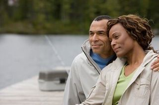 Mature Couple Sitting on Pier Embracing - Counseling in Crown Point and Munster, IN