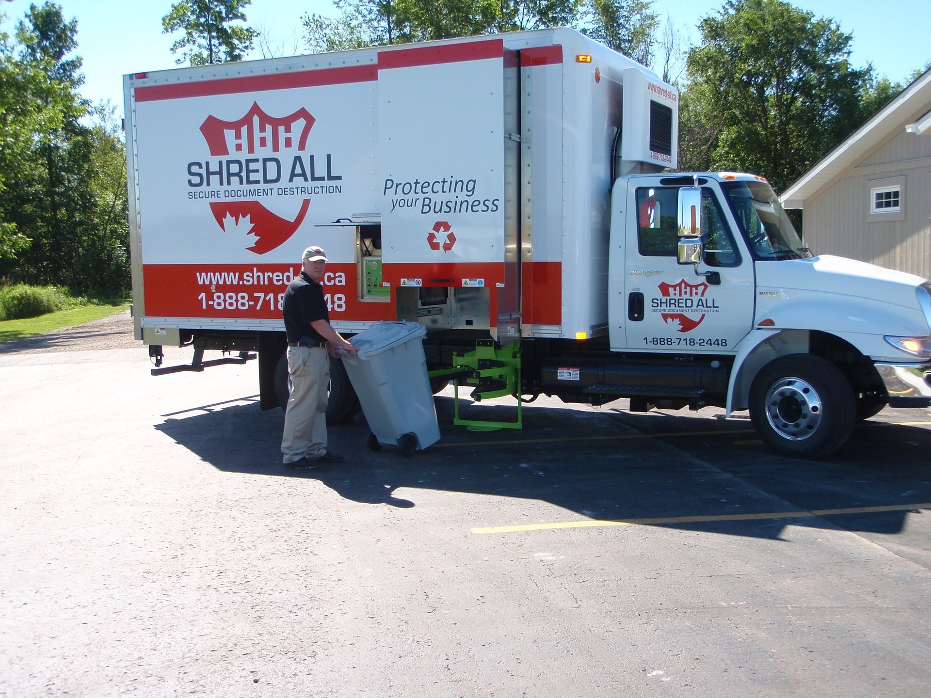A shred all truck is parked in a parking lot