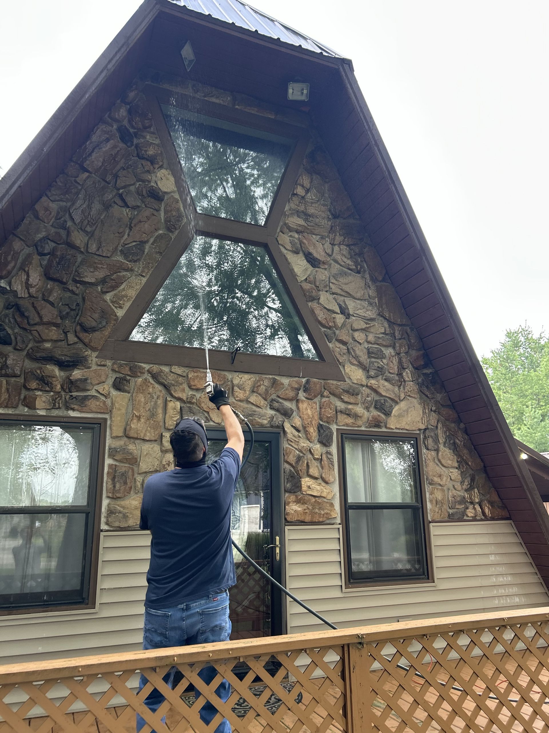 Pest control worker using a sprayer near a kitchen cabinet base. Pest control worker using a sprayer near a kitchen cabinet base.