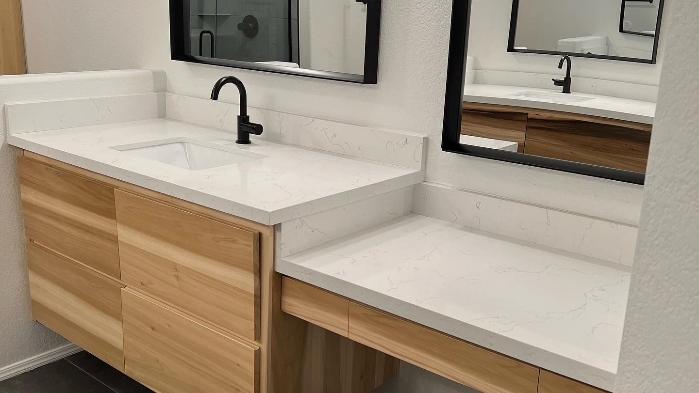 A bathroom with two sinks and two mirrors.