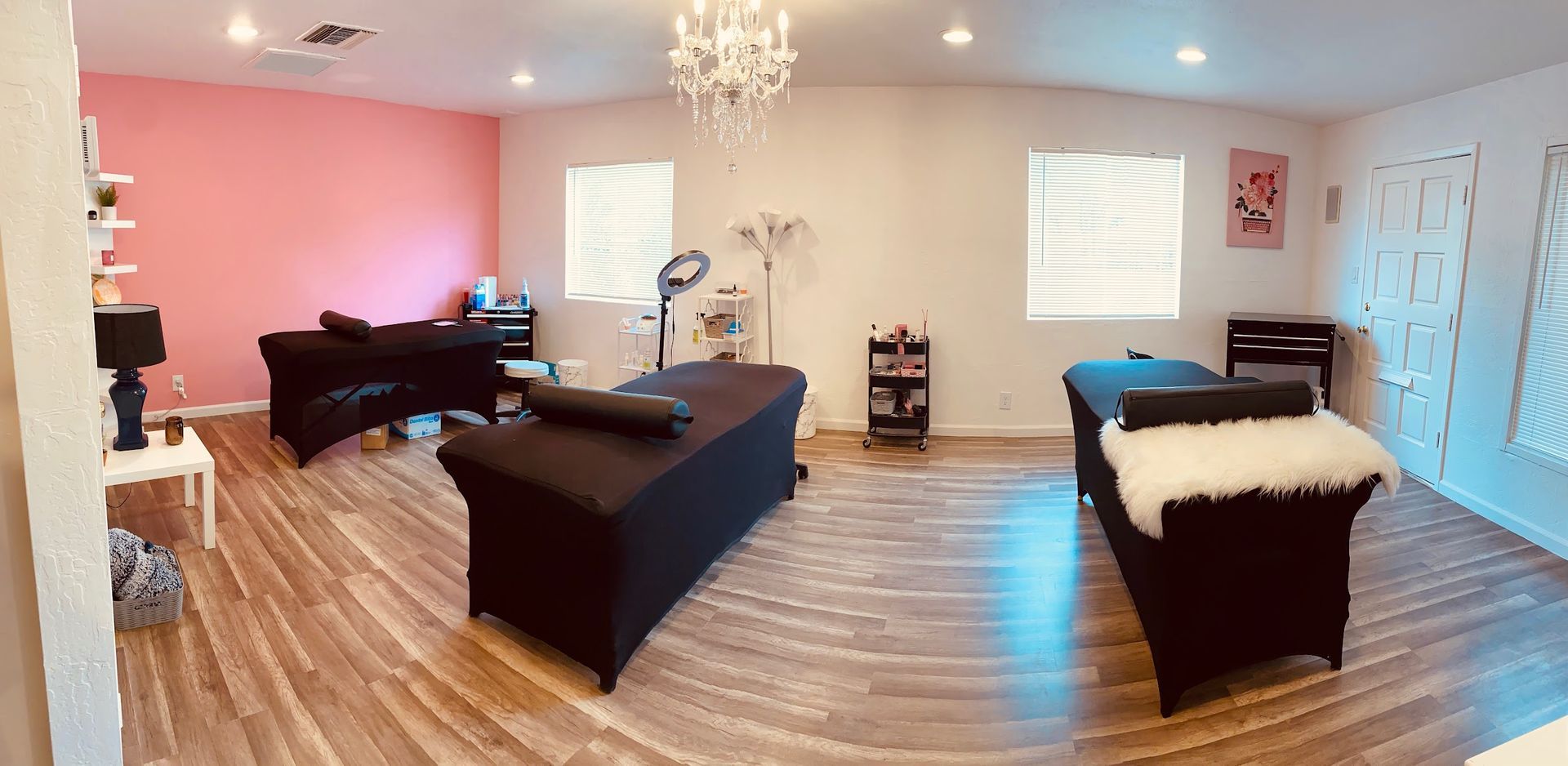 A room with two tables and a chandelier in it.