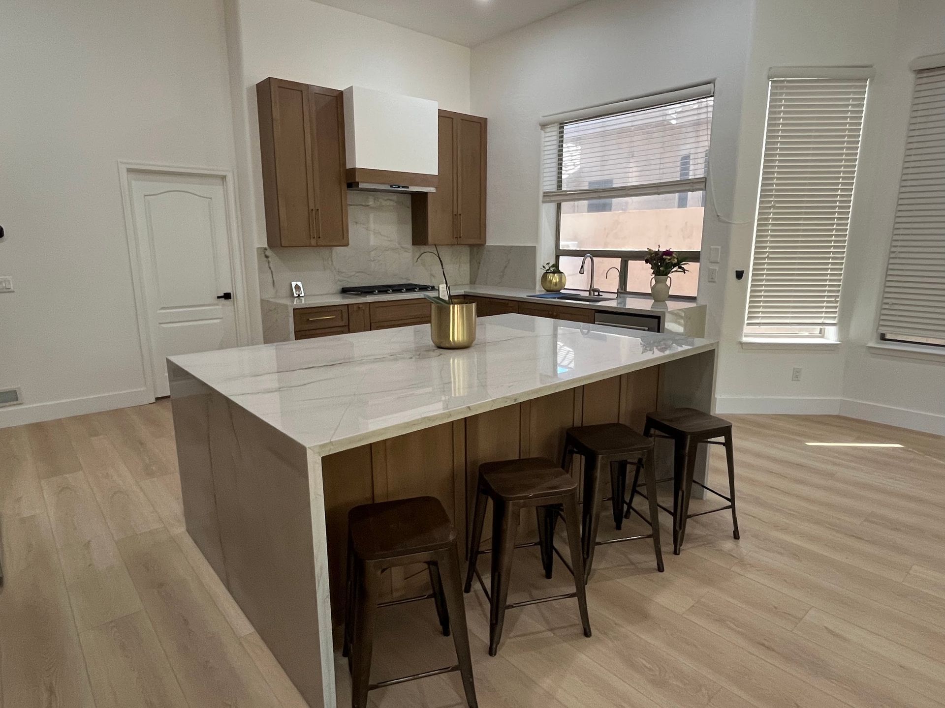 A kitchen with a large island and stools