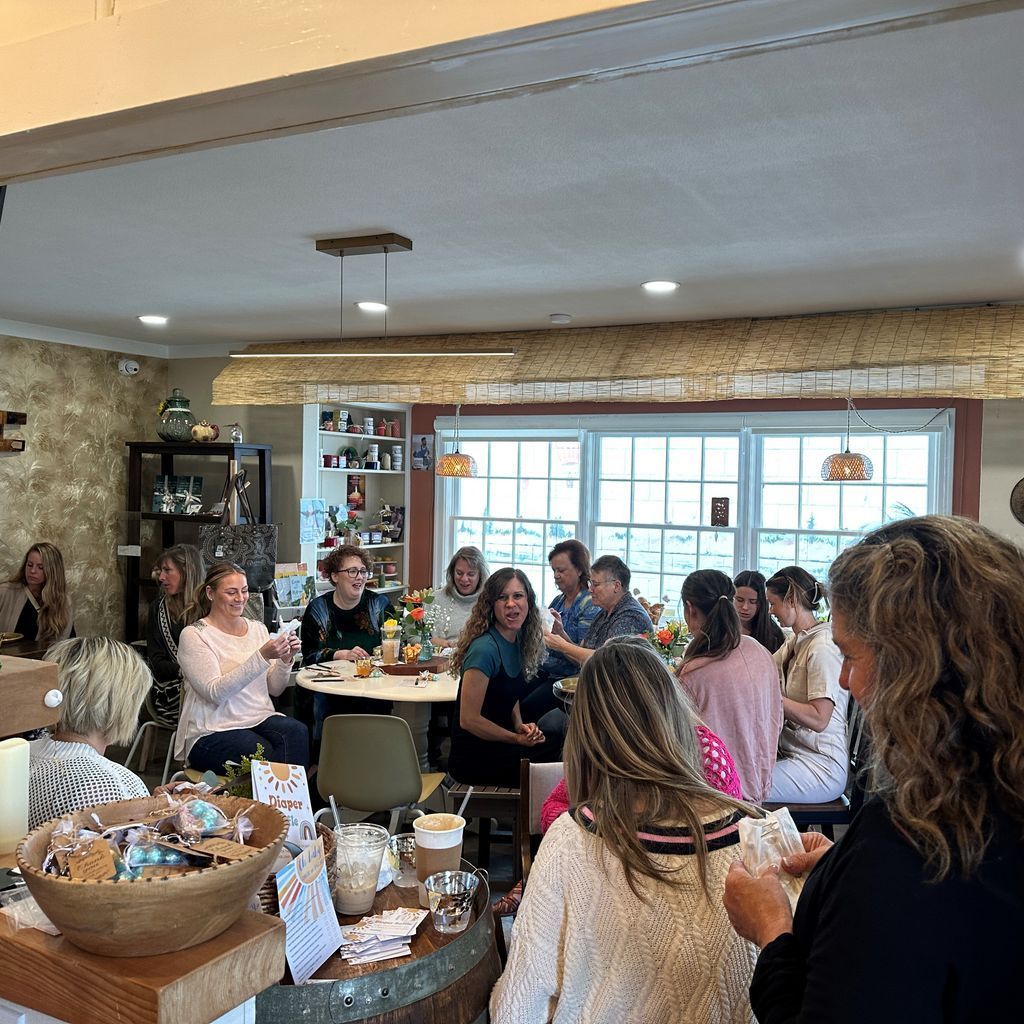 A group of people are sitting at tables in a room.