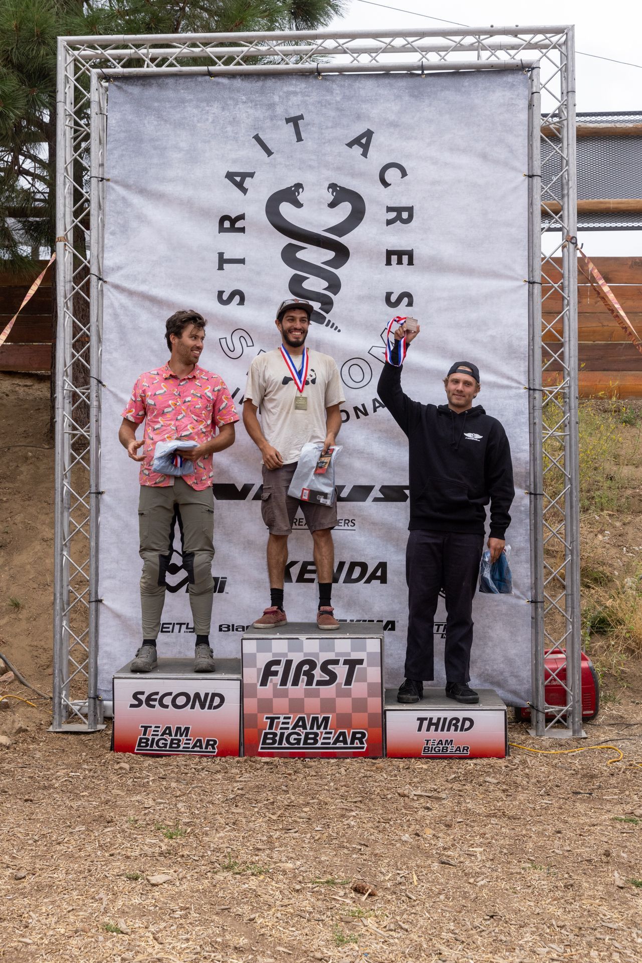 Podium with three men; 