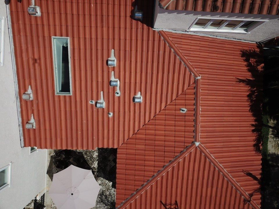 An aerial view of a house with a red tiled roof.