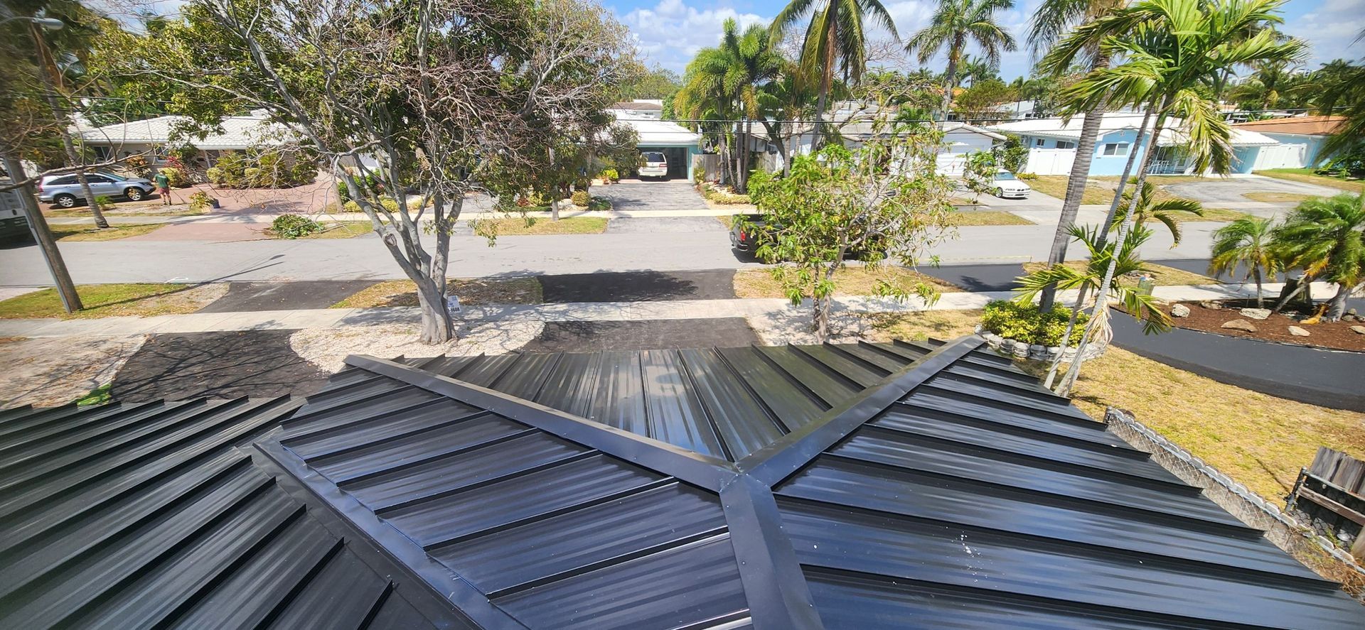 A view of a black roof from the top of a house.