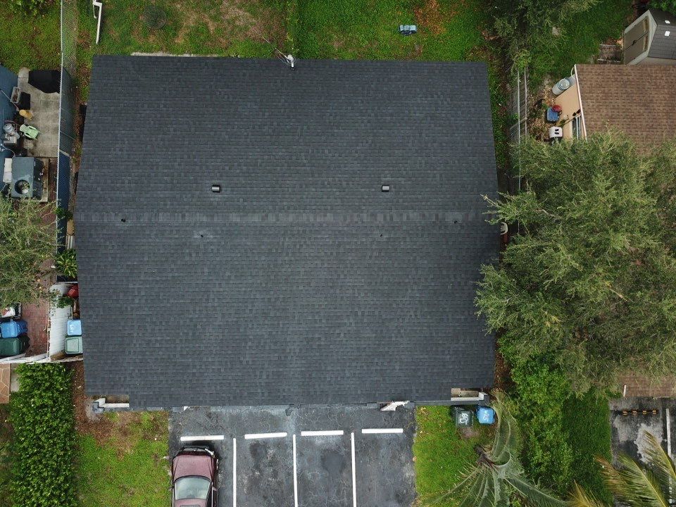 An aerial view of a house with a car parked in front of it.