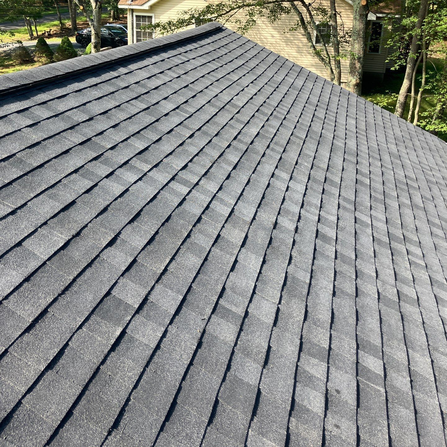 A close up of a roof with shingles and a gutter.